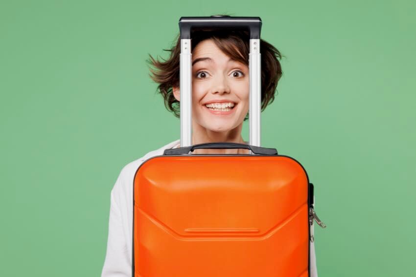 Suitcase female traveller AdobeStock